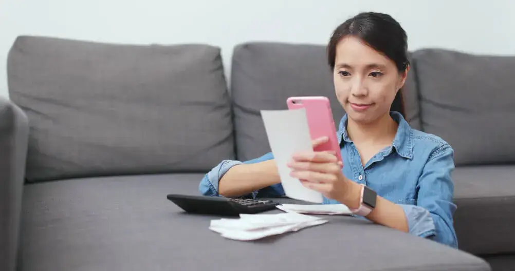 Woman taking a photo of a receipt 